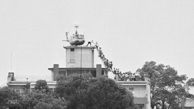 A CIA employee (probably O.B. Harnage) helps Vietnamese evacuees onto an Air America helicopter from a rooftop near the US embassy in Ho Chi Minh City, then known as Saigon, in 1975.

