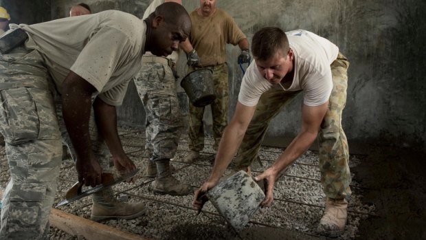 US airmen and Australian soldiers pour floor concrete during Balikatan 2017 in Ormoc City, Leyte. 