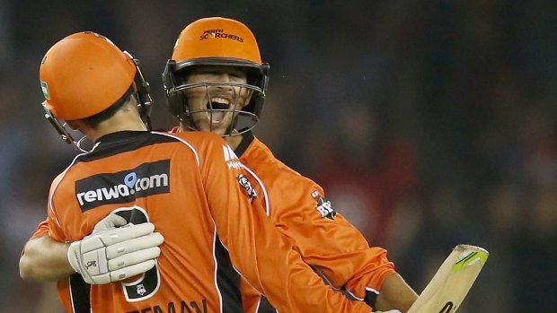 Ashton Agar celebrates with team mate Sam Whitman of the Perth Scorchers after hitting a 6 on the final ball to win the match on Thursday night.