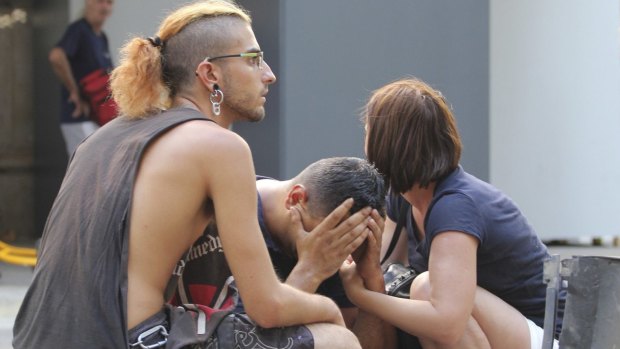 Injured people react after a van crashed into pedestrians in downtown Barcelona.