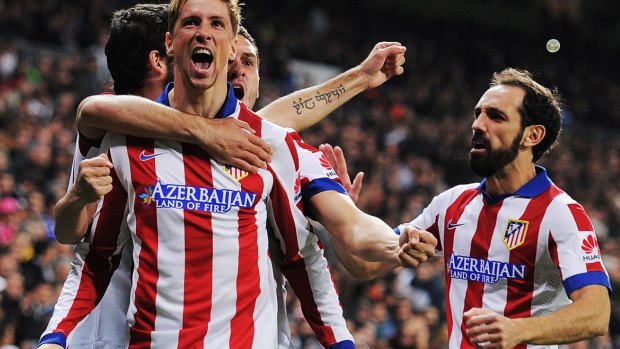 Double delight: Fernando Torres celebrates his return to boyhood club Atletico Madrid with two goals against Real Madrid.