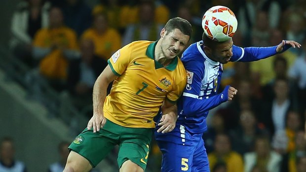 Forward Mathew Leckie challenges Fahad Alhajeri of Kuwait for the ball in the Socceroos' Asian Cup opener.
