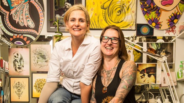 Breast-cancer survivor Alyson Anderson (left) and tattoo artist Mim d'Abbs, who covered Alyson's double mastectomy scars and reconstruction with a tattoo.