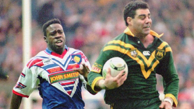 Glory days: Mal Meninga breaks away from Martin Offiah at Old Trafford in Manchester in 1994.