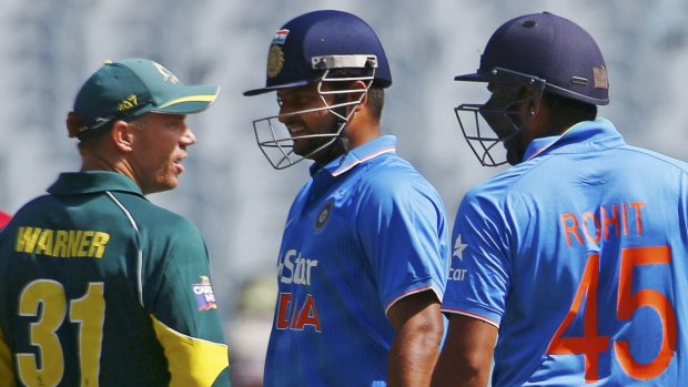 David Warner argues with Suresh Raina and Rohit Sharma during the one-day international at the MCG on Sunday.