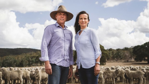 Local farmers John Reardon and Tina Freund stand on their property, just over a ridge from the range.