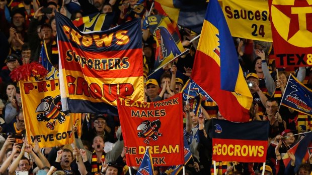 Raising the colours: Crows will take the grand final experience to London. 