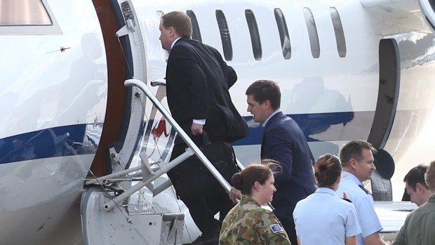 Former prime minister Tony Abbott staffer Richard Dowdy, at top of the stairs, boards Mr Abbott's RAAF VIP Challenger in Canberra on Friday.