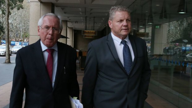 Craig Izzard (right) leaves ICAC in September 2016, after giving evidence into allegations he turned a blind eye to asbestos dumping in his role at a western Sydney Council.