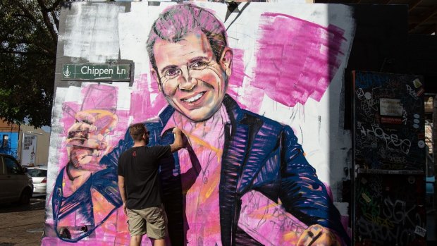Artist Scott Marsh paints a mural of NSW Premier, Mike Baird holding a kebab and glass of wine. Initiatives by the Baird government, such as a recent roundtable to develop policies for improving the city's night life, have been welcomed by businesses.