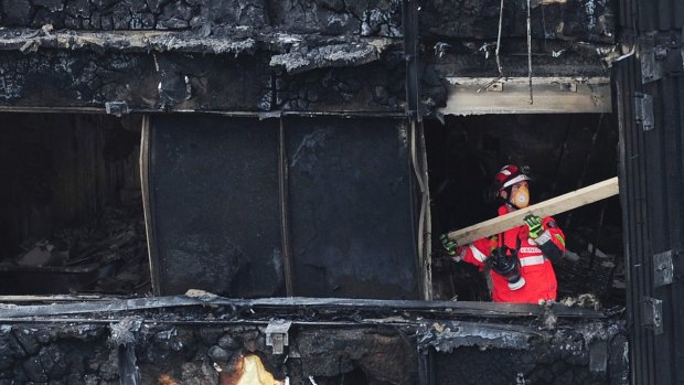 A London firefighter inside the charred Grenfell Tower.