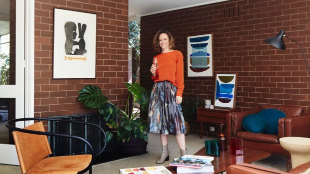 Stephanie in the lounge room. “The Charles Blackman silkscreen [left] has been in my family for years,” she says, “and the oil paintings are by Hannah Nowlan, a young artist I represent at my store Open Room.”
