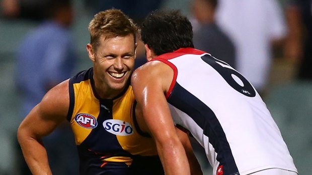 Birds of a feather: Eagles' Sam Mitchell shares a moment with Demons' Jordan Lewis.