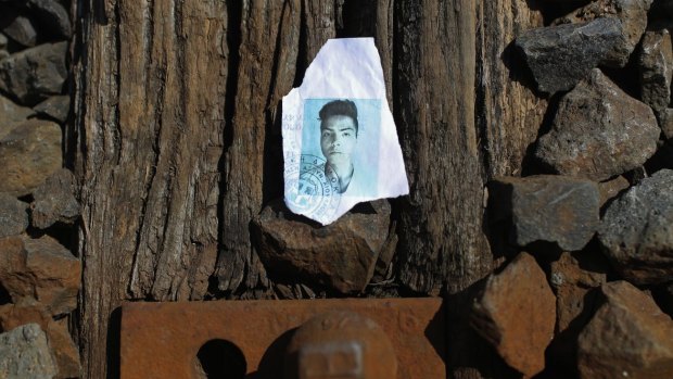 A discarded, torn and ripped identity document of a migrant sits on the railway tracks as hundreds of migrants and refugees continue to cross the border from Serbia into Hungary.