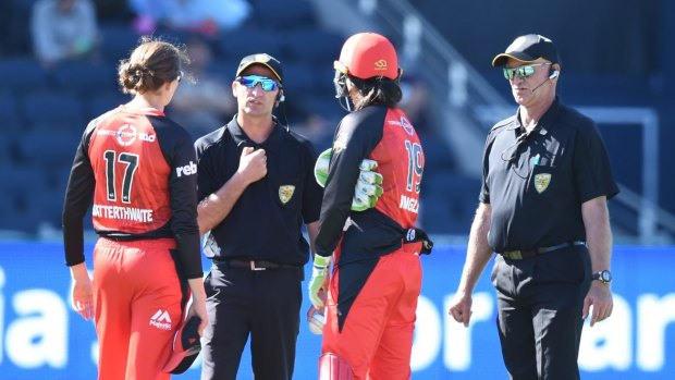 Confusion: Renegades players Amy Satterthwaite and Emma Inglis talk to the umpires.