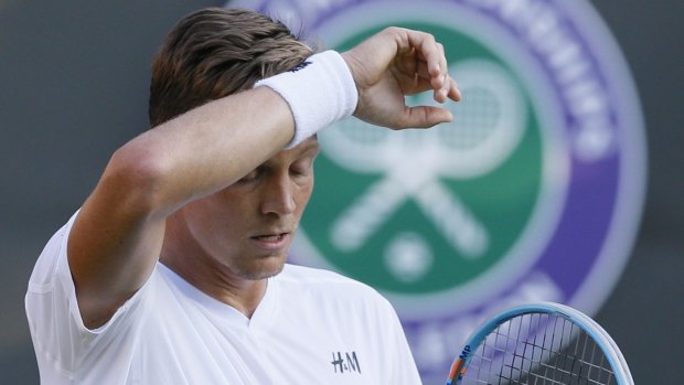 Tomas Berdych of the Czech Republic wipes his face during the singles first round match at Wimbledon.