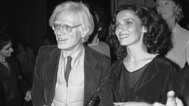 With artist Andy Warhol at a party in 1978.