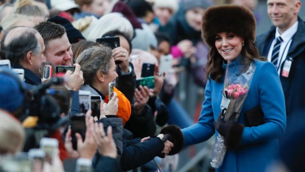 Kate Duchess of Cambridge is greeted by spectators in front of the Norwegian Royal Palace in Oslo.