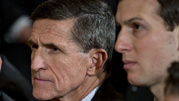 Michael Flynn, former US national security adviser, centre and Jared Kushner, senior White House adviser, right.