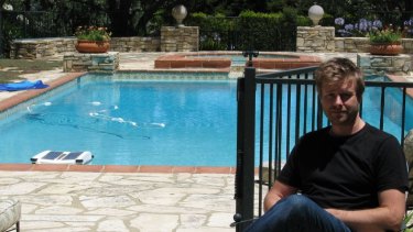 Entrepreneur and chief executive officer of LIFX, Phil Bosua, sits beside his company's pool.