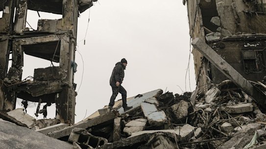 A resident looks for belongings in an apartment building destroyed during fighting between Ukrainian and Russian forces in Borodyanka, Ukraine, Tuesday, April 5, 2022. (AP Photo/Vadim Ghirda)