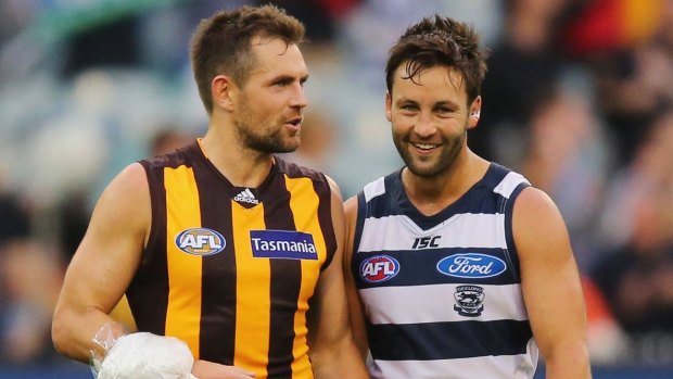   Luke Hodge of the Hawks, talks to Jimmy Bartel of the Cats, after last year's match between the fierce rivals.