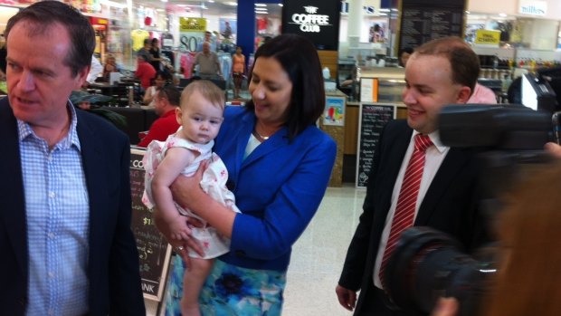 Opposition Leader Annastacia Palaszczuk, with federal counterpart Bill Shorten and Stretton candidate Duncan Pegg, delivers the first official baby cuddle of the Labor campaign to 12-month-old Larissa Soter of Sunnybank Hills.