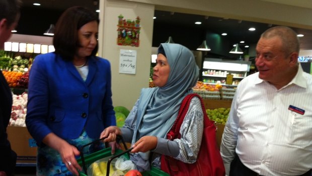 Opposition Leader Annastacia Palaszczuk talks about a possible GST on
fresh fruit with Arya Putri from Kuraby at Sumnybank Hills Shopping
Centre. Labor's Sunnybank candidate, lawyer Peter Russo, watches on.