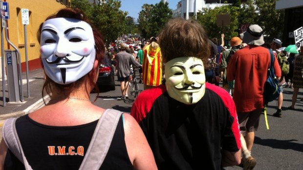 Protesters wearing Guy Fawkes masks take to the streets during G20 in Brisbane.