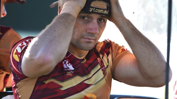Painful exit: Queensland halfback Cooper Cronk is driven away for treatment after suffering an ankle injury during the Maroons training session at Sanctuary Cove on Friday.