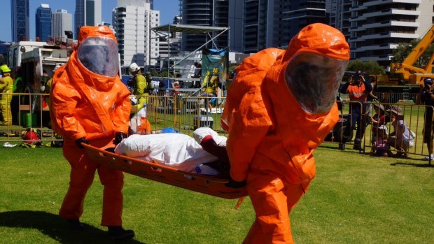 Team members carry a 'casualty' during the Mining Emergency Response Exercise.