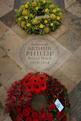 Wreaths surround the memorial stone.