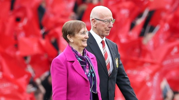 Bobby Charlton and his wife, Norma Ball, on the Old Trafford pitch to see Old Trafford's South Stand officially renamed the Sir Bobby Charlton Stand.