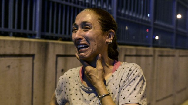 A woman stands and cries outside Istanbul's Ataturk airport after the explosions.