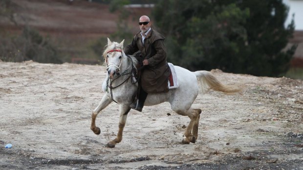 Mamdouh Elomar goes for his ride on his family property at Denham Court near Campbelltown on Tuesday.