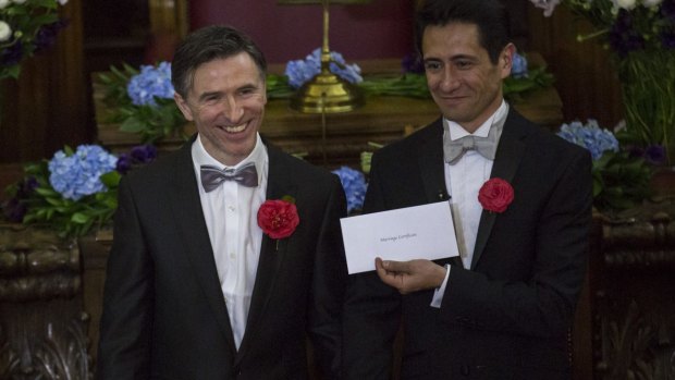 Peter McGraith (centre) and David Cabreza are married at Islington Town Hall in one of Britain's first same-sex weddings on March 29, 2014 in London.