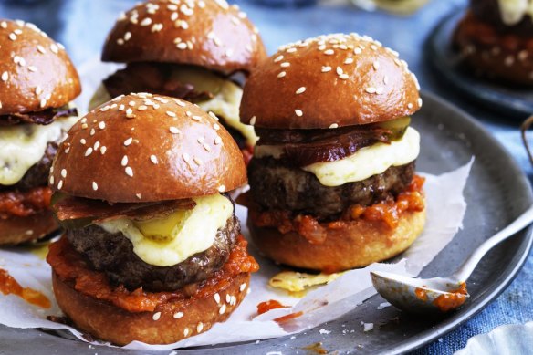 Beef sliders with bacon, cheese and pickles.