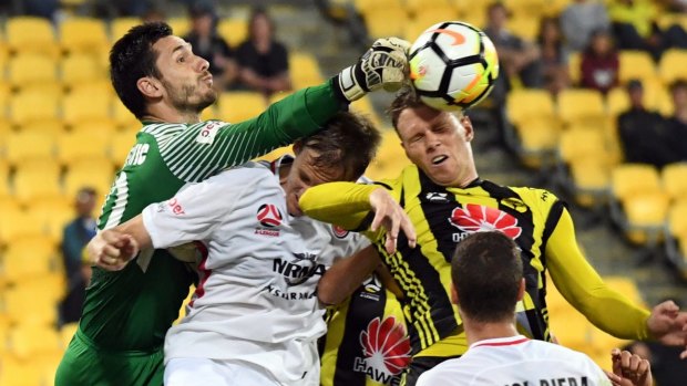 Congestion: Vedran Janjetovic of the Wanderers punches the ball away during a frantic finish at Westpac Stadium.