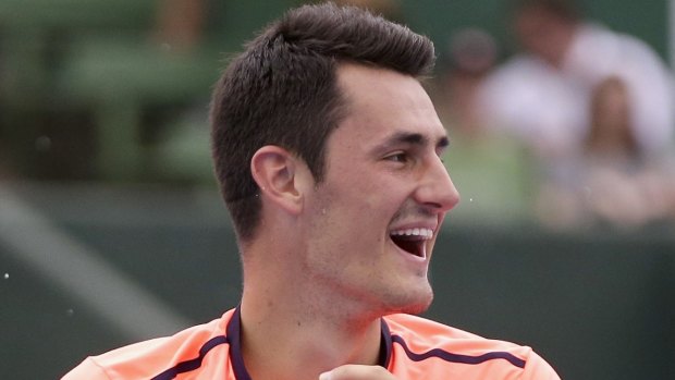 Bernard Tomic laughs during a change of ends in his match against Gilles Simon at Kooyong.
