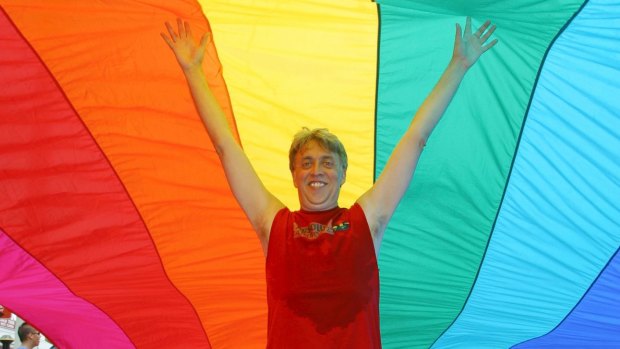 Gilbert Baker stands under a two-kilometre-long rainbow flag in Key West, Florida, 2003. 