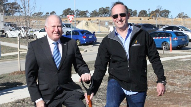 Planning Minister Mick Gentleman and Kirk Coningham from the Master Builders Association turn a sod at Moncrieff in November 2014. 
