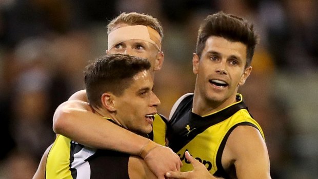Up and about: Trent Cotchin and the Tigers celebrate after the skipper kicked a goal at the MCG.