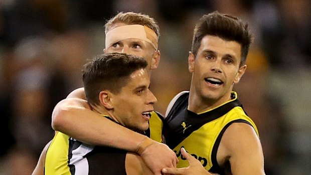 Up and about: Trent Cotchin and the Tigers celebrate after the skipper kicked a goal at the MCG.