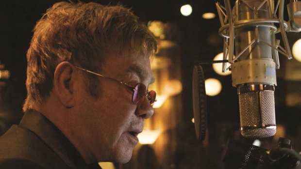 Elton John in the recording studio: he plans to reduce his hectic touring schedule but says "I'll always play". 