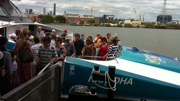 Hundreds of residents look through one of the city's new CityCats, Nar-DHA, at the opening of the new Bulimba CityCat and ferry terminal.