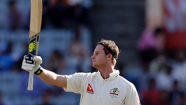 Captain's knock: Steven Smith raises his bat to celebrate scoring his century against India in the third Test.