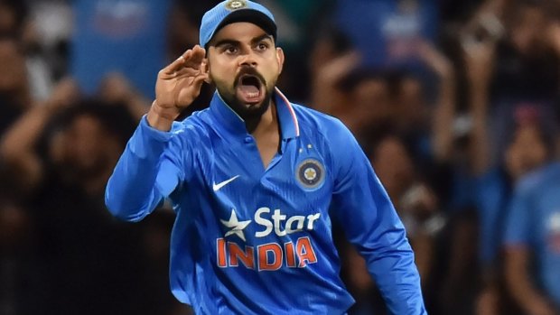 Stop talking ... Virat Kohli of India reacts after taking a catch to dismiss Steven Smith, who was commentating as he played.