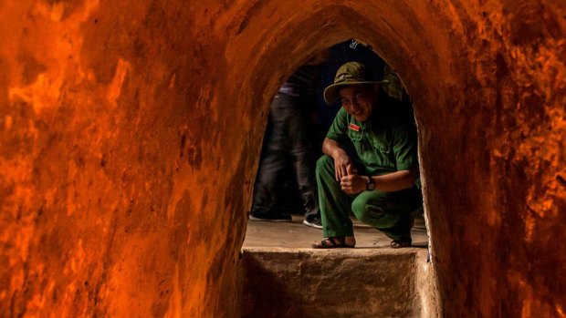  A Vietnamese tour guide sits inside the Cu Chi tunnels, on the outskirts of Ho Chi Minh City.