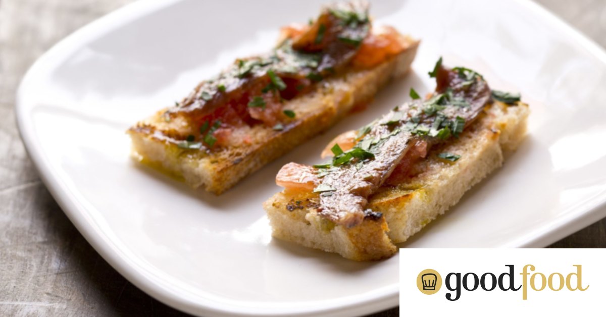Anchovy toasts with tomato and garlic