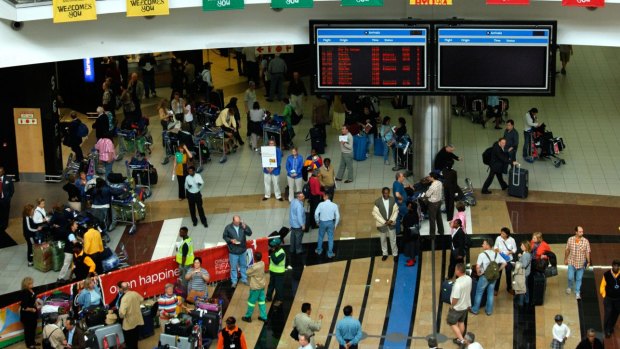 Travellers in the arrival hall of the O.R. Tambo International Airport (ORTIA) in Johannesburg, South Africa.